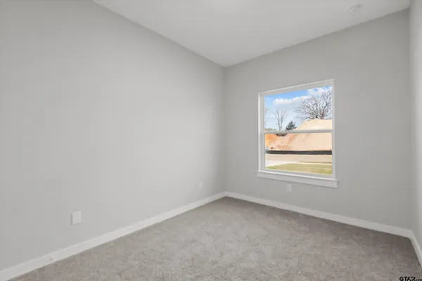 a bedroom with a bed and a potted plant