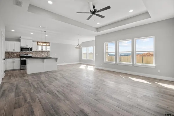 a view of a kitchen with a sink stainless steel appliances and cabinets