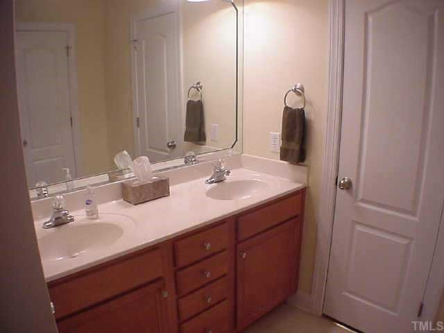5032 Contender Drive Raleigh, NC 27603 - Photo 8 of 12 Master bath with double sink. Master closet is off bathroom and has walk-in storage over the garage. Other