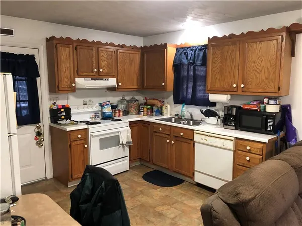 a kitchen with a sink cabinets and window