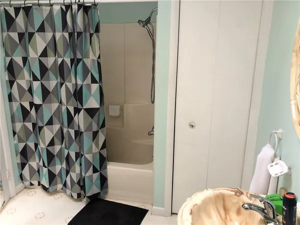 a bathroom with a bathtub and shower