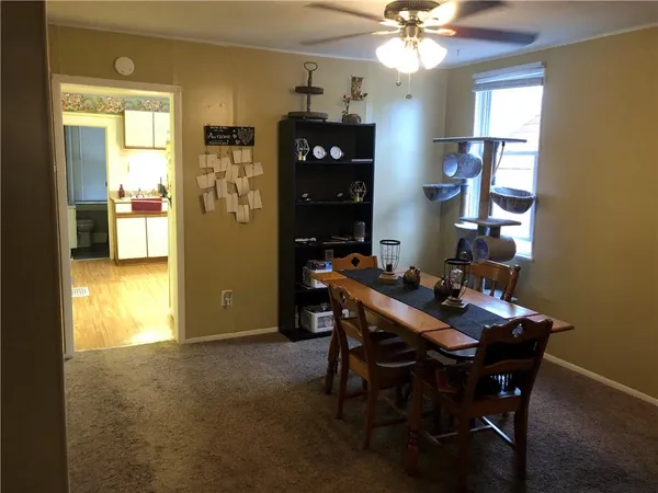 a view of a dining room with furniture and chandelier