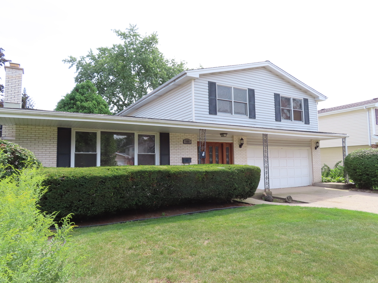 169 Sunrise Drive Wheeling, IL 60090 - Photo 3 of 5 a front view of a house with garden