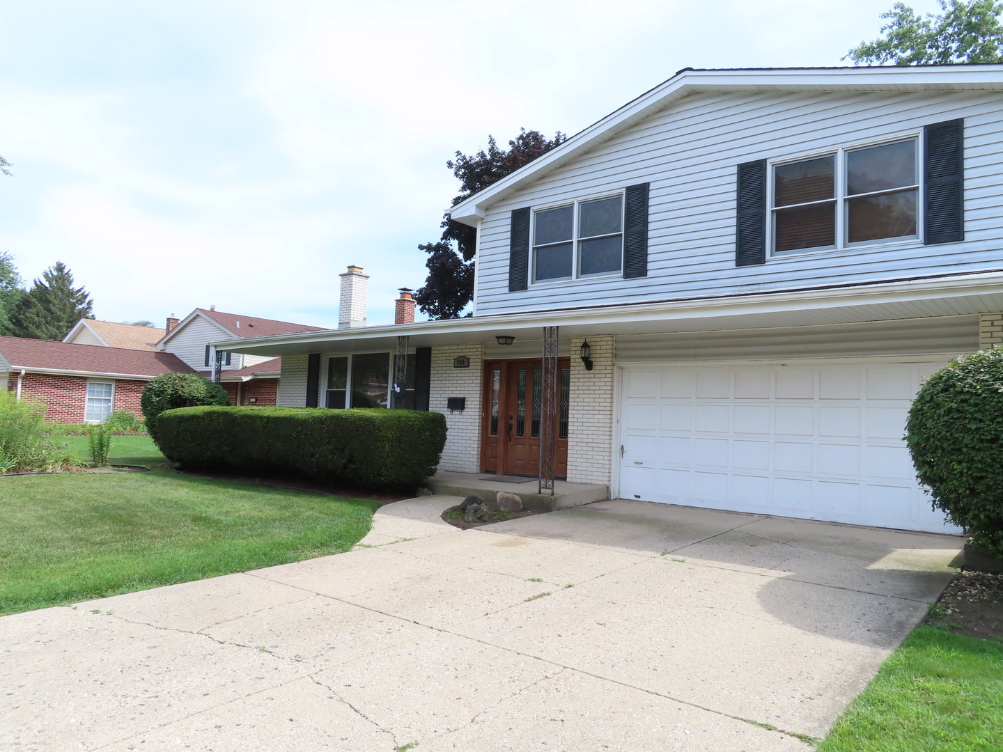 169 Sunrise Drive Wheeling, IL 60090 - Photo 4 of 5 a front view of a house with garden