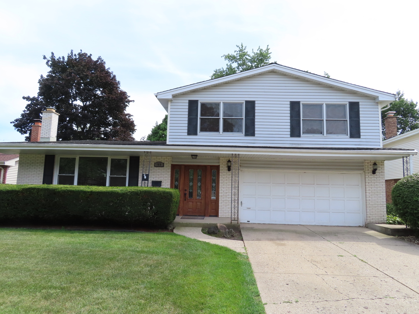 169 Sunrise Drive Wheeling, IL 60090 - Photo 5 of 5 a front view of a house with a garden