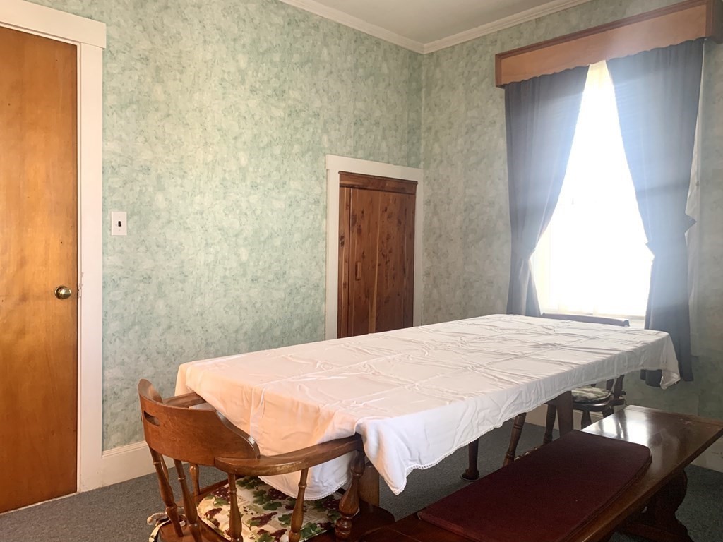 85 Division Street Fall River, MA 02721 - Photo 14 of 42 a dining room with a table and chairs
