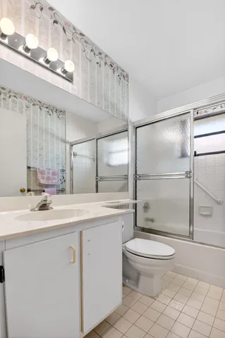 a front view of a house with a yard and potted plants