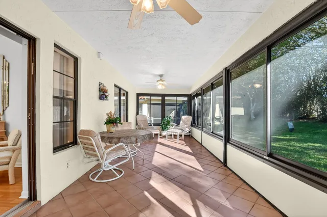 an outdoor space with seating area and trees in the background