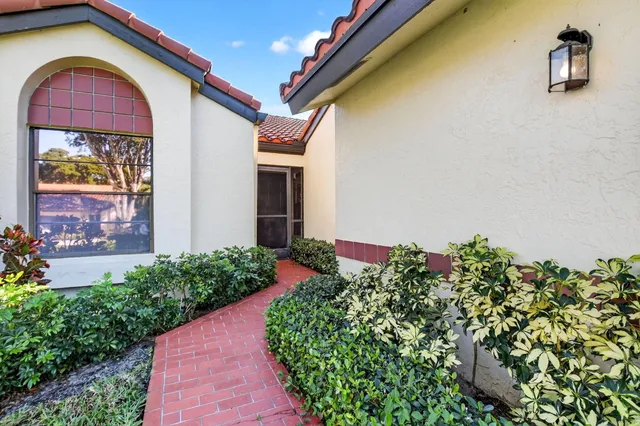 a front view of a house with a yard and fountain