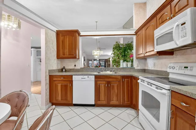 a kitchen with granite countertop cabinets stainless steel appliances a sink and a counter top space