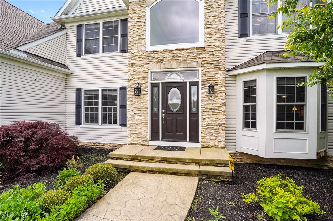 7305 Alexander Road Painesville, OH 44077 - Photo 13 of 50 Doorway to property featuring stone front and bay window