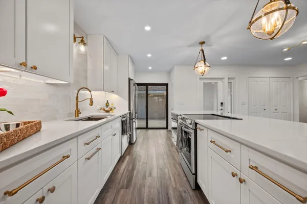 a view of a room with wooden floor fan and windows
