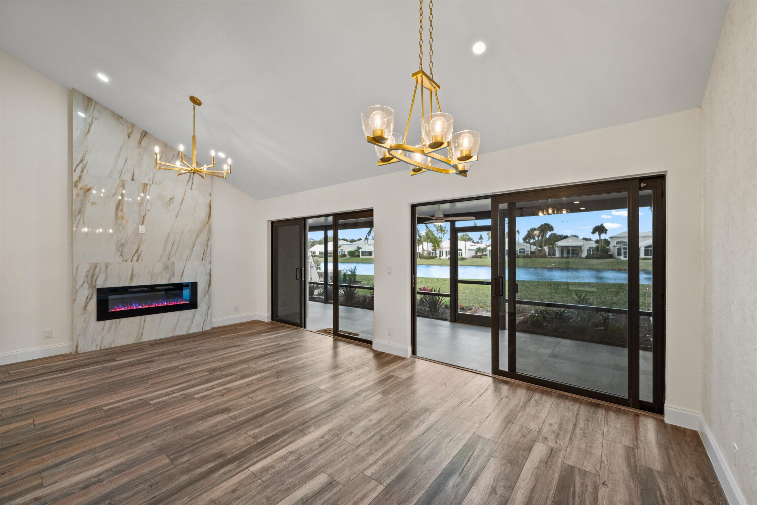 3733 Cape Pointe Circle Jupiter, FL 33477 - Photo 14 of 63 a view of an empty room with wooden floor and a window