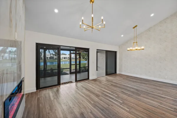 an empty room with wooden floor and a window