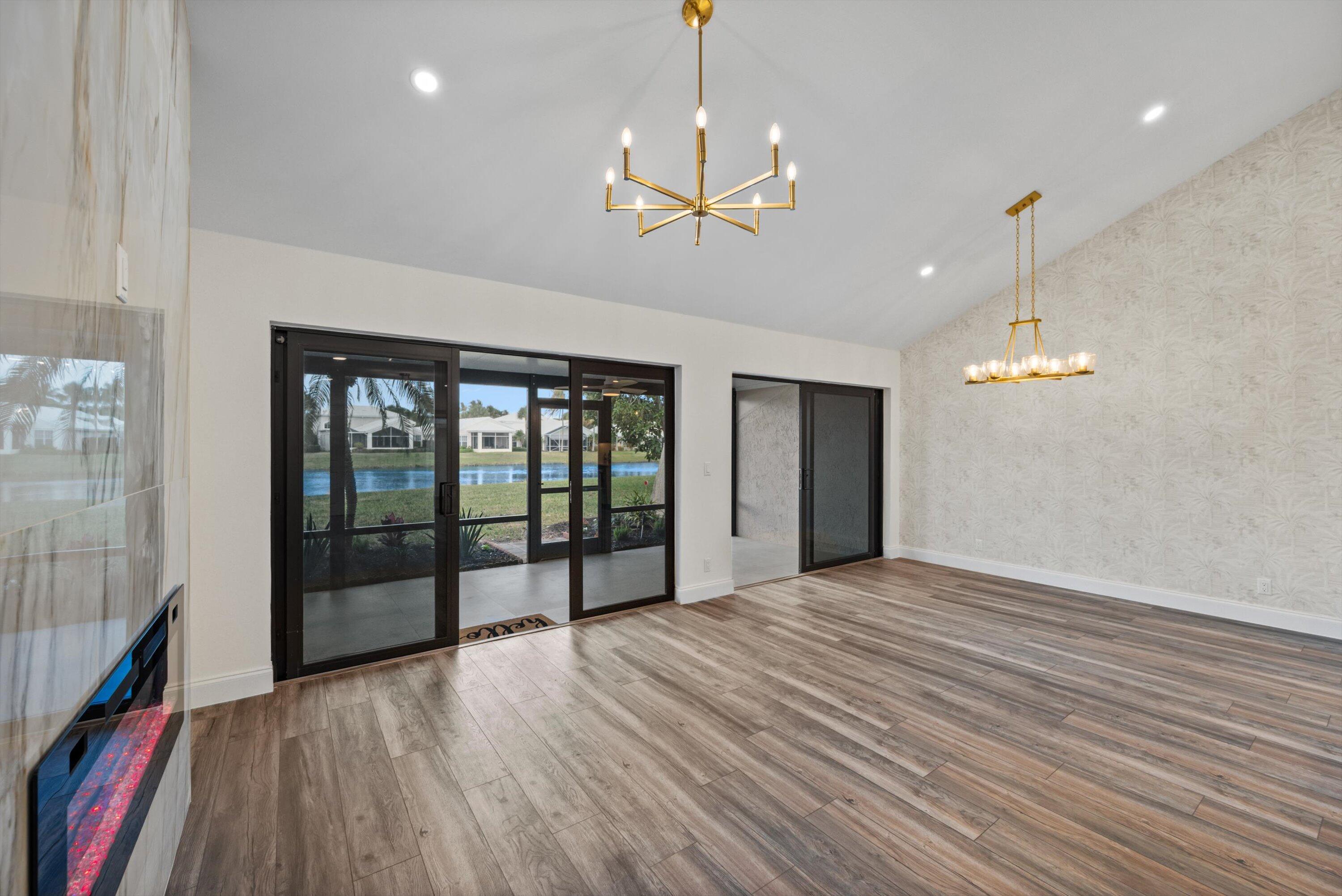 3733 Cape Pointe Circle Jupiter, FL 33477 - Photo 15 of 63 a view of a room with wooden floor fan and windows