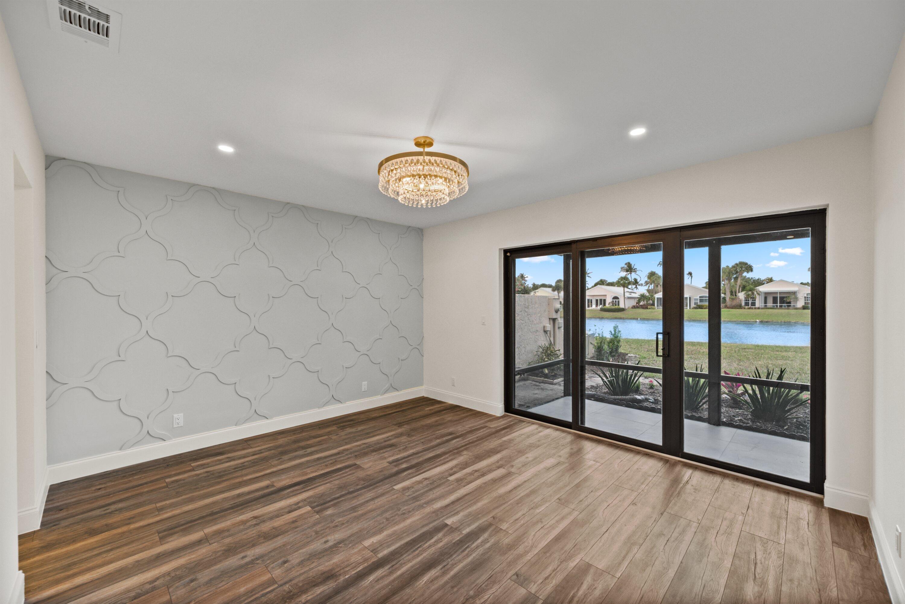 3733 Cape Pointe Circle Jupiter, FL 33477 - Photo 16 of 63 wooden floor in an empty room with a window