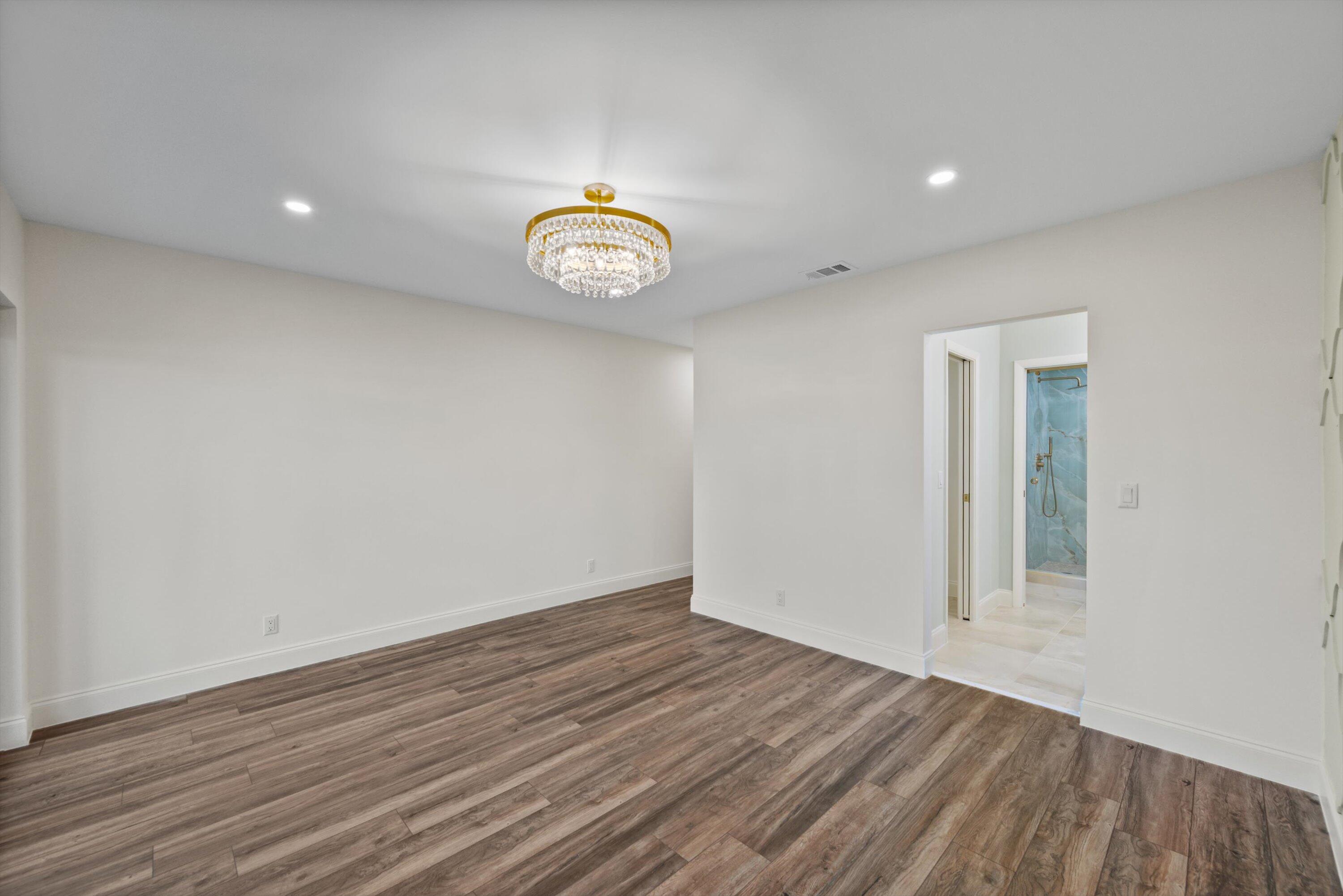 3733 Cape Pointe Circle Jupiter, FL 33477 - Photo 17 of 63 an empty room with wooden floor and a window