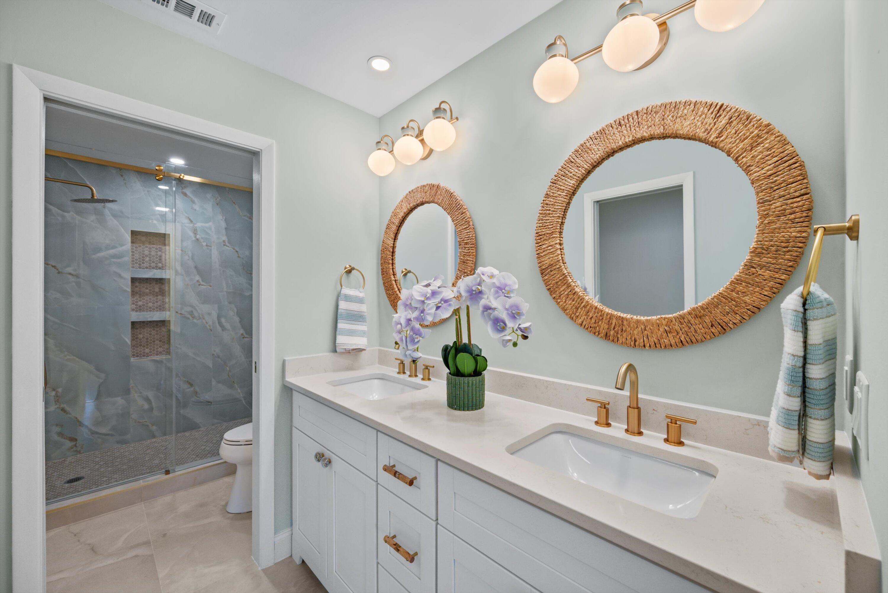 3733 Cape Pointe Circle Jupiter, FL 33477 - Photo 18 of 63 a bathroom with a granite countertop mirror and a sink