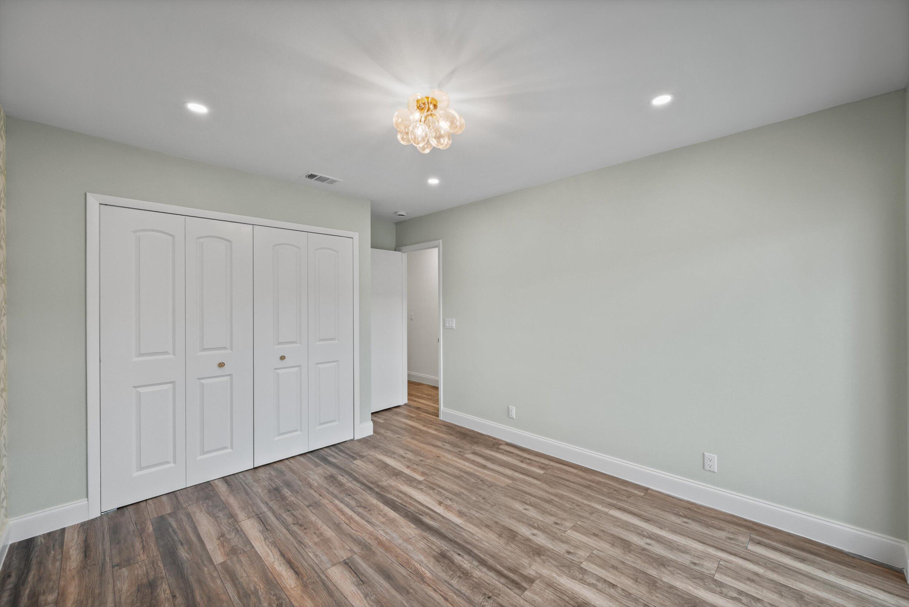 3733 Cape Pointe Circle Jupiter, FL 33477 - Photo 22 of 63 a view of an empty room with wooden floor