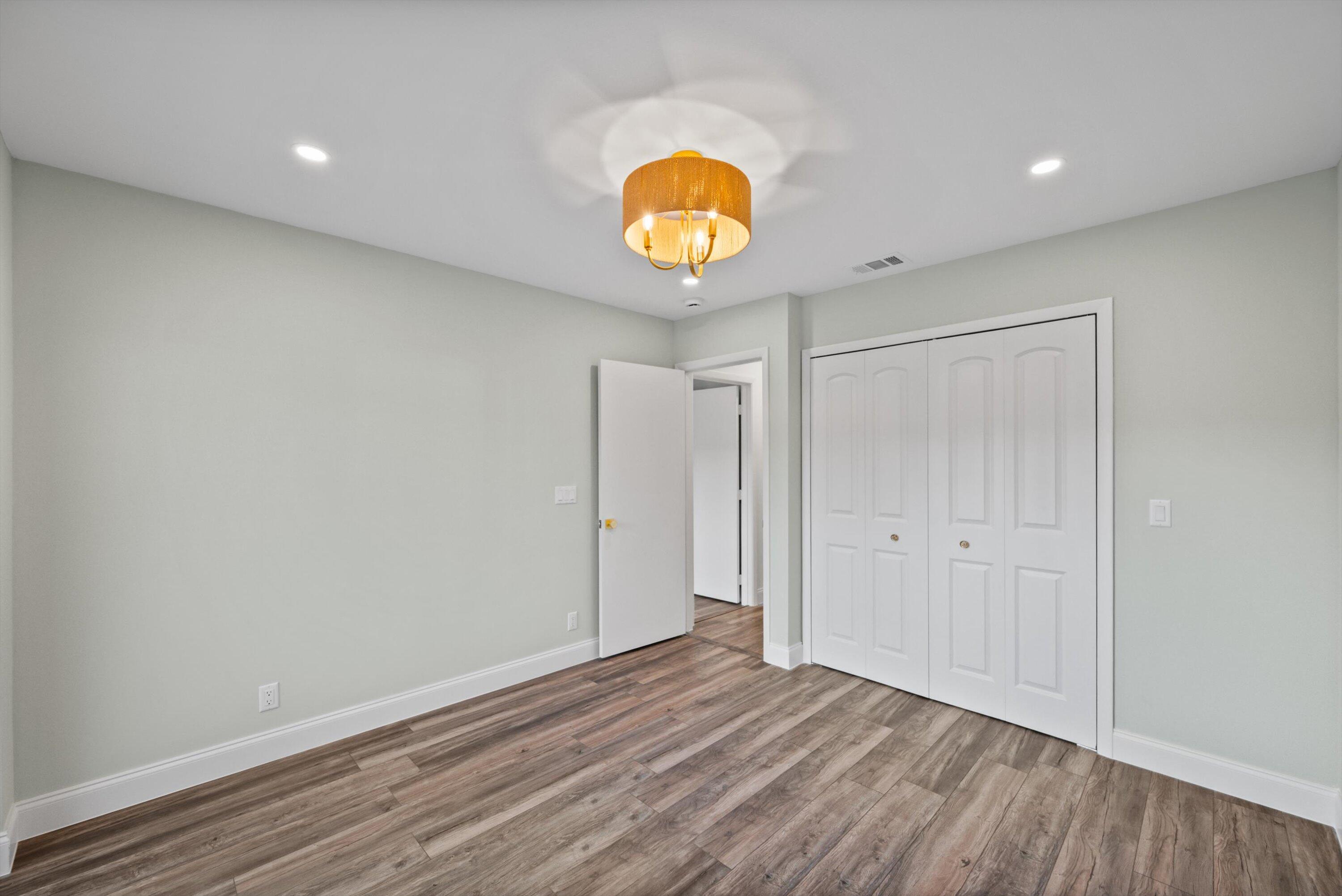 3733 Cape Pointe Circle Jupiter, FL 33477 - Photo 23 of 63 a view of an empty room with wooden floor and window