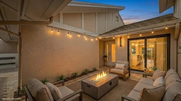 a living room with furniture a chandelier and a large window