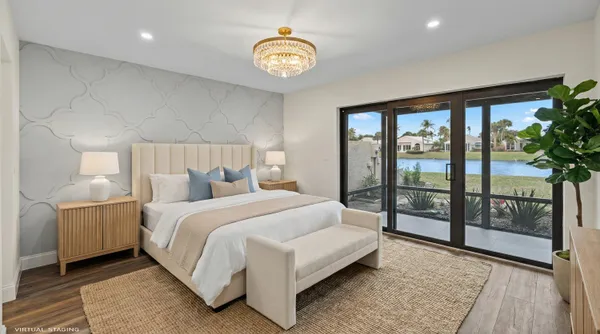 a bedroom with a large bed and a chandelier