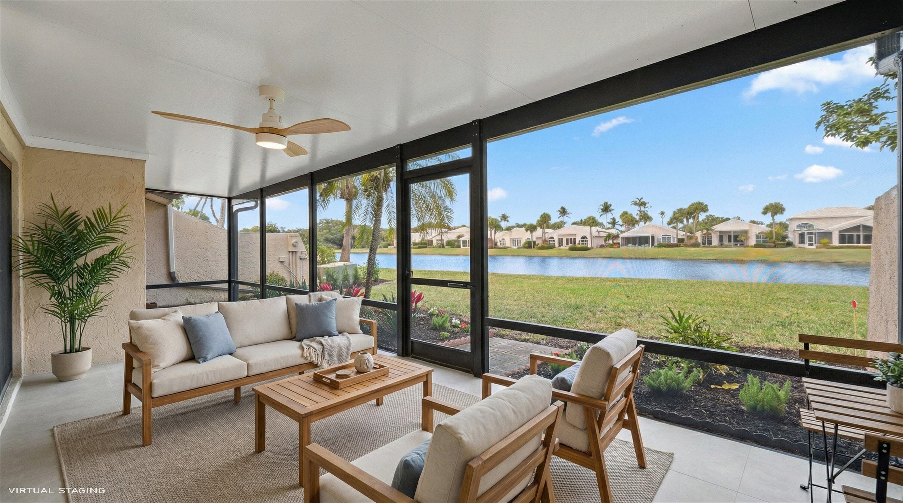 3733 Cape Pointe Circle Jupiter, FL 33477 - Photo 34 of 63 a living room with furniture and a floor to ceiling window