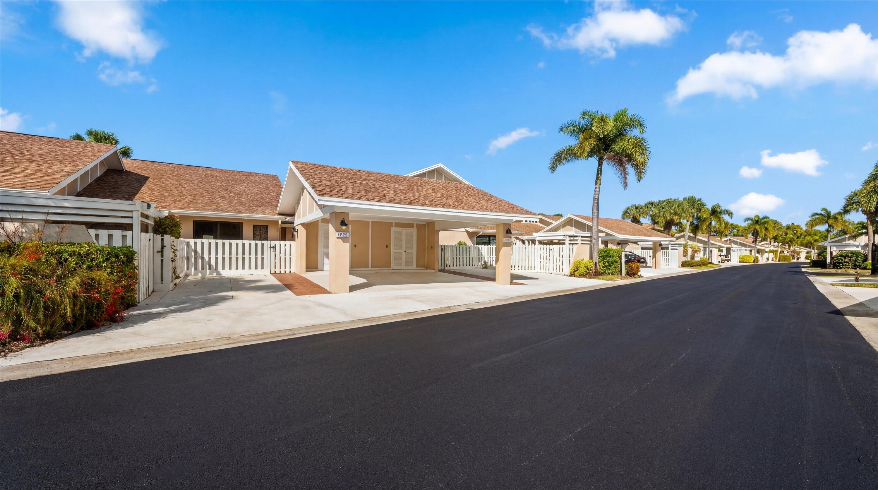 3733 Cape Pointe Circle Jupiter, FL 33477 - Photo 37 of 63 a front view of a house with a garden and a yard