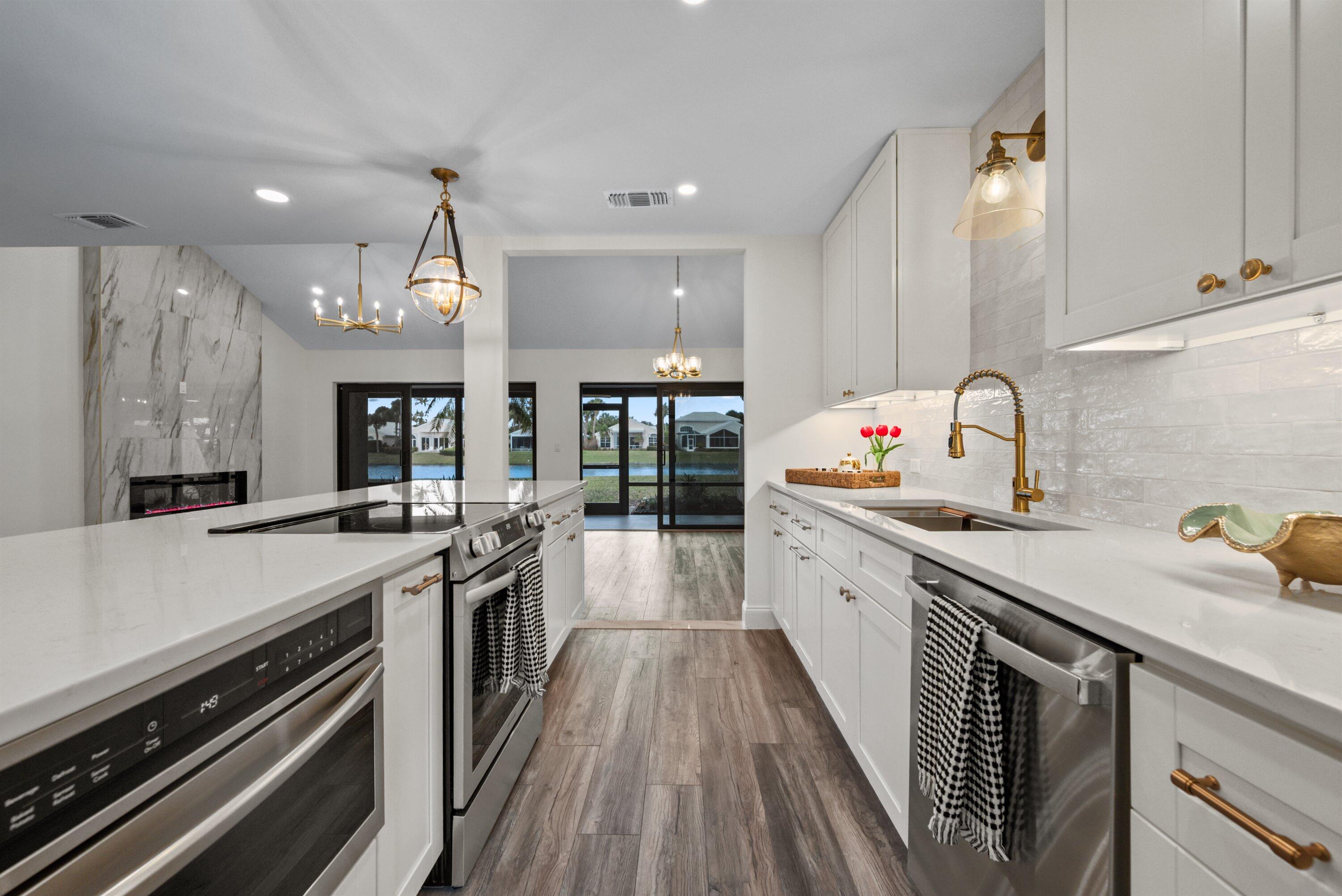 3733 Cape Pointe Circle Jupiter, FL 33477 - Photo 46 of 63 a kitchen with stainless steel appliances a sink stove and cabinets