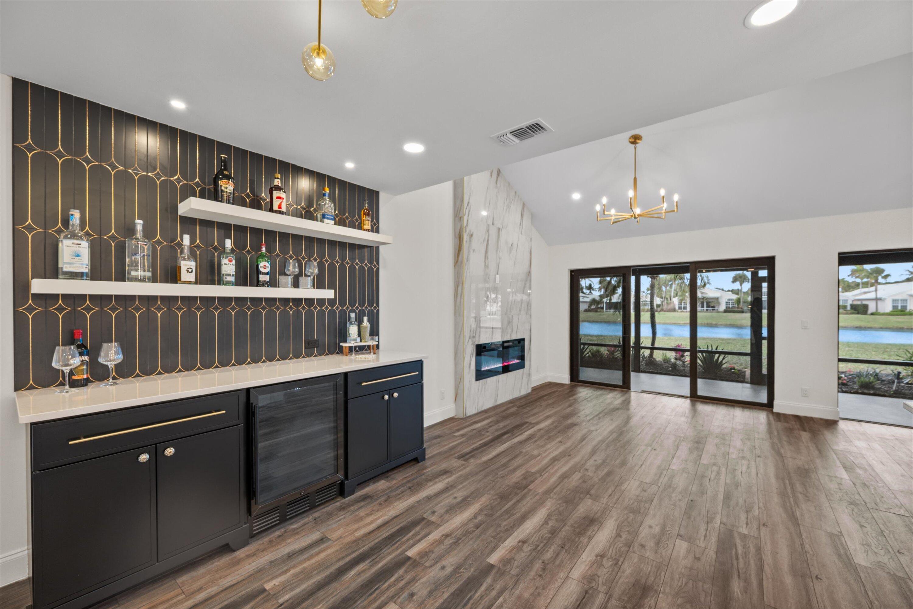 3733 Cape Pointe Circle Jupiter, FL 33477 - Photo 5 of 63 a open kitchen with kitchen island a large counter space a sink and cabinets