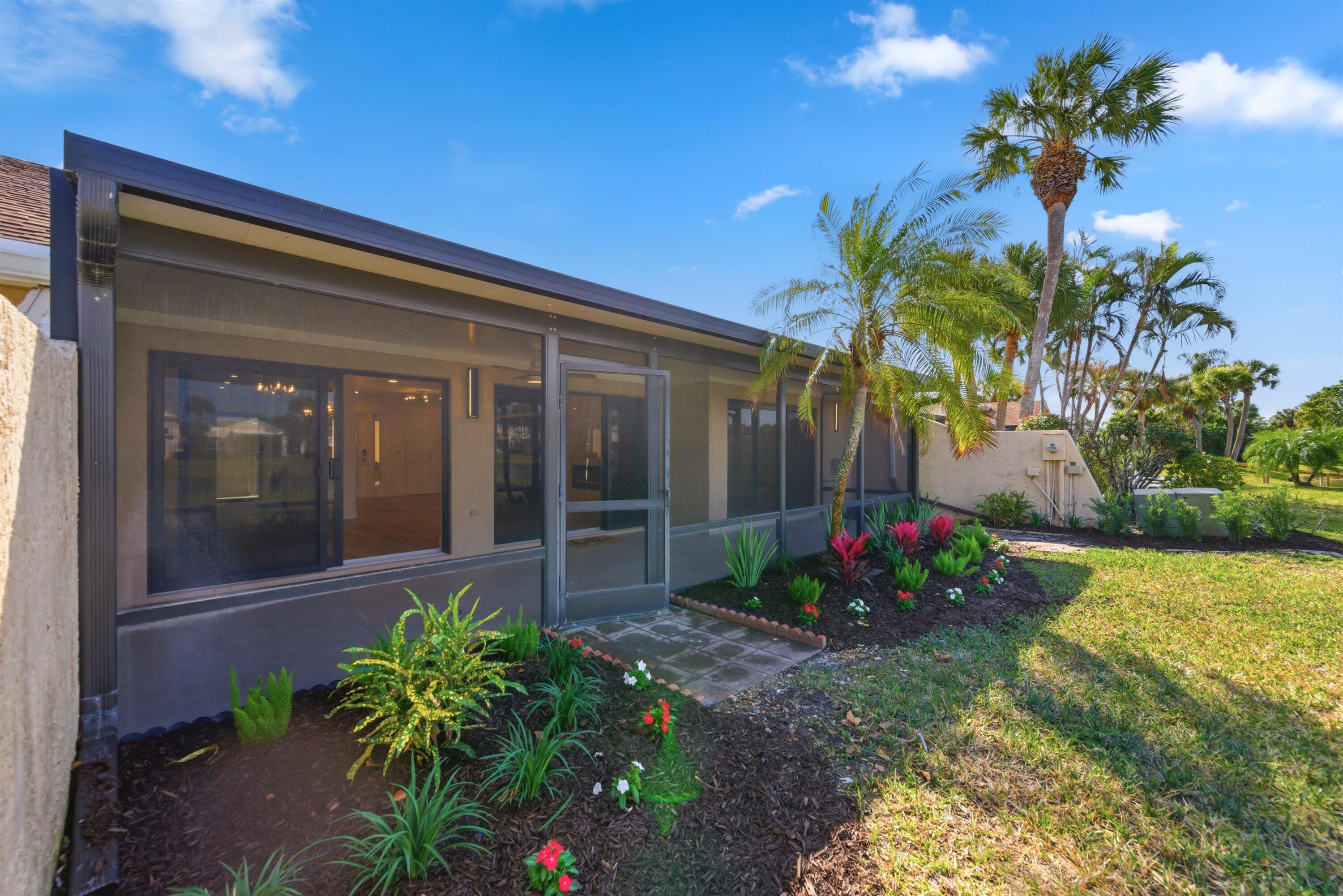 3733 Cape Pointe Circle Jupiter, FL 33477 - Photo 53 of 63 a front view of a house with a yard