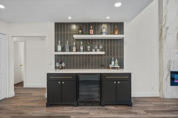 a large kitchen with kitchen island a sink stainless steel appliances and cabinets