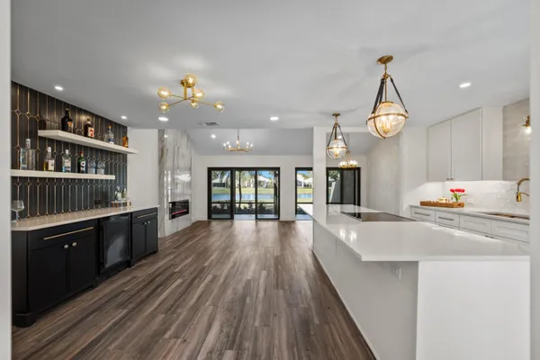 a kitchen with stove a sink and refrigerator