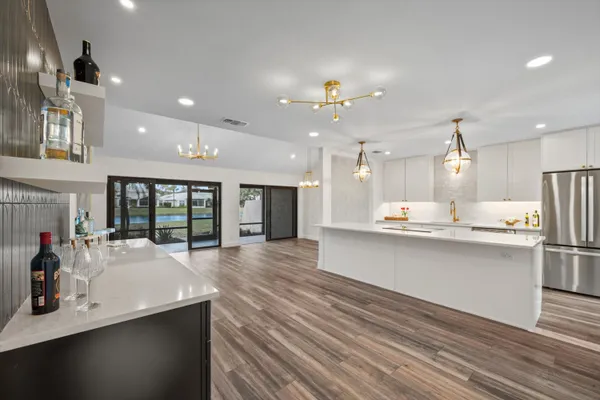 a kitchen with lots of counter space and wooden floor