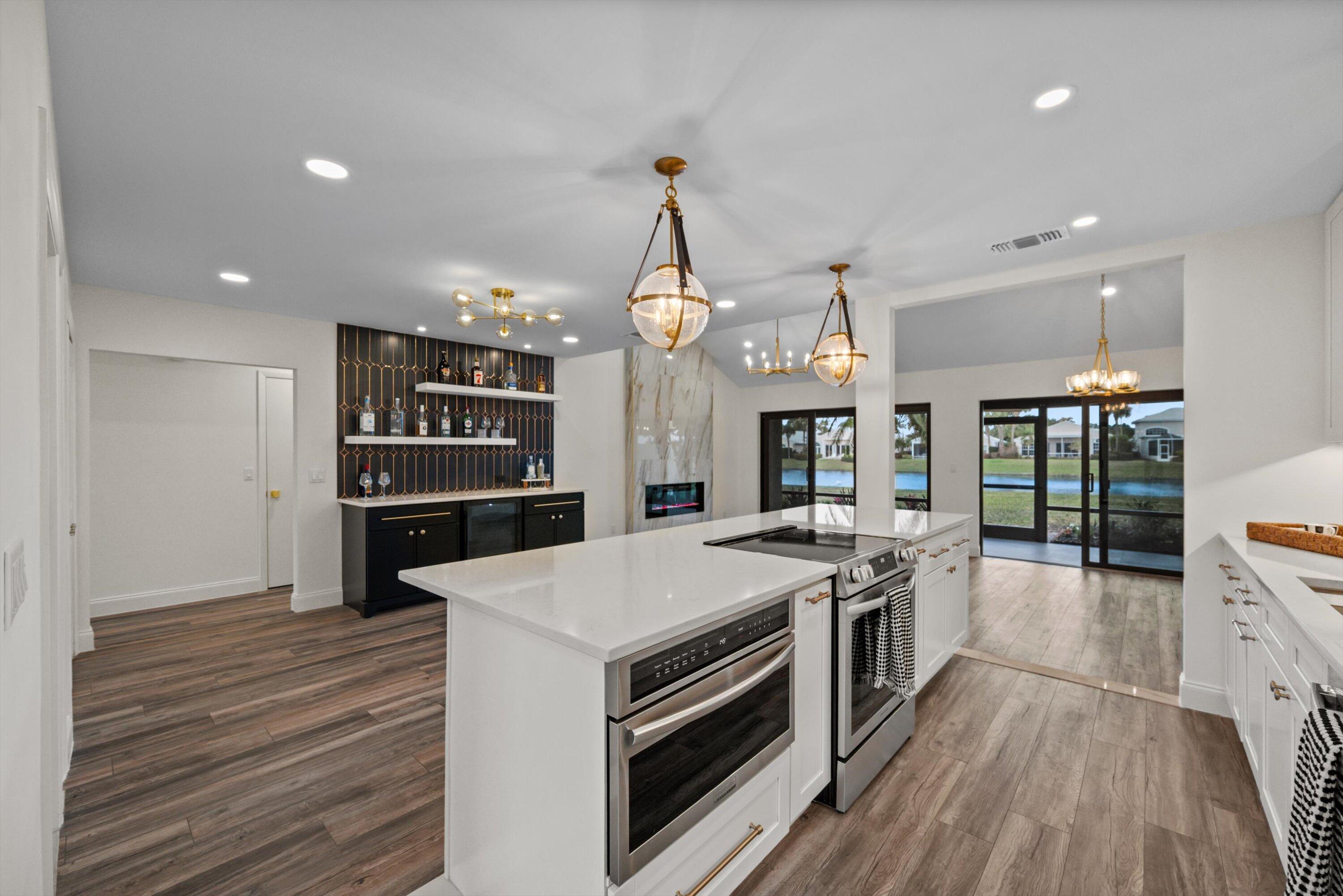 3733 Cape Pointe Circle Jupiter, FL 33477 - Photo 9 of 63 a kitchen with stove a sink and refrigerator