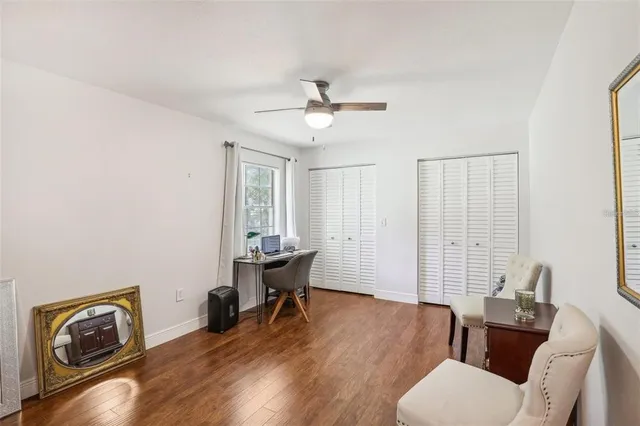 a living room with furniture and wooden floor