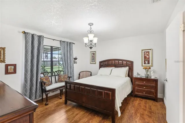 a bedroom with a bed and a chandelier