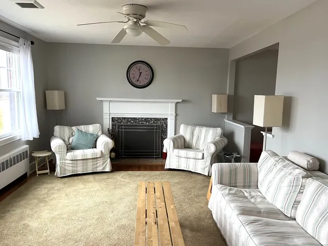 a living room with furniture and a fireplace