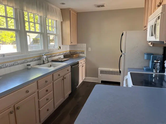 a kitchen with a sink stove and cabinets