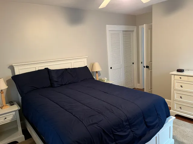 a bedroom with a bed cabinet and window