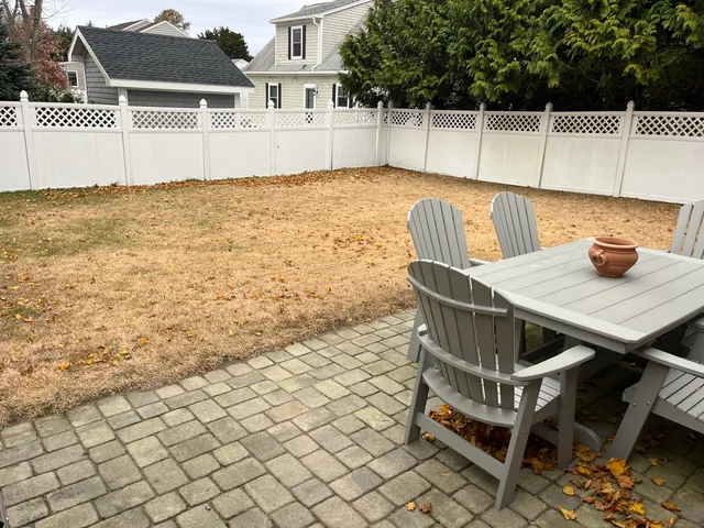 a view of a patio with table and chairs