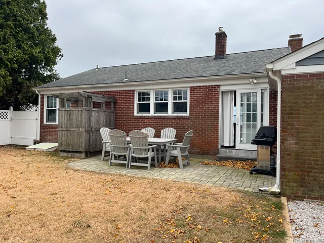 a backyard of a house with yard and outdoor seating
