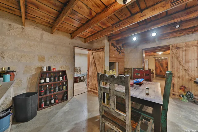 a view of a room with lots of furniture and clutter