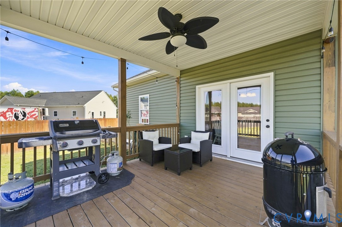 8718 Rock Cedar Road New Kent, VA 23124 - Photo 34 of 43 Covered wood deck with a ceiling fan, string light