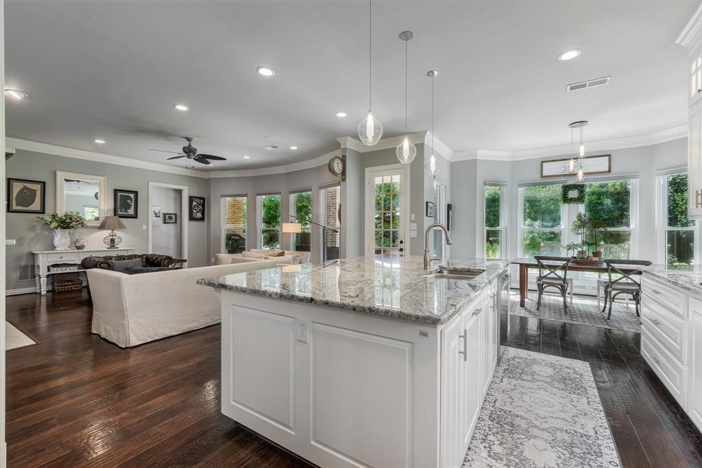 a dining hall with stainless steel appliances granite countertop a stove and cabinets