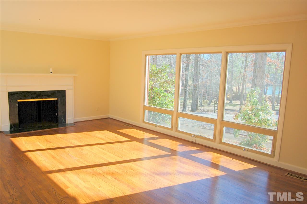 409 Goodwin Road Durham, NC 27712 - Photo 3 of 25 a view of empty room with wooden floor and fireplace