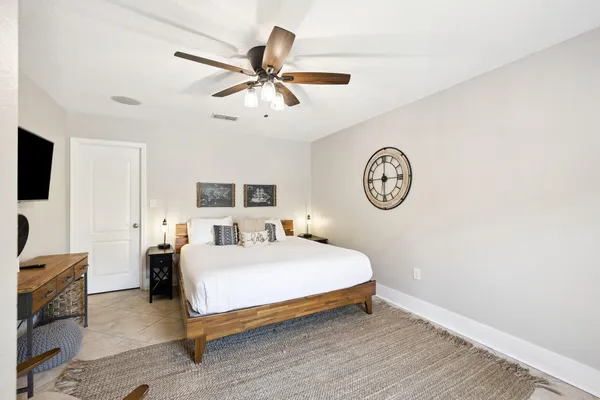 a bedroom with a bed and a chandelier