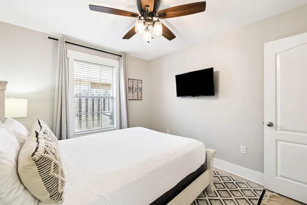 a bedroom with a bed and a flat screen tv