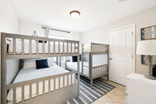 a bedroom with furniture a baby crib and a window