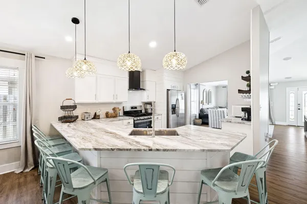 a dining table with chairs and chandelier